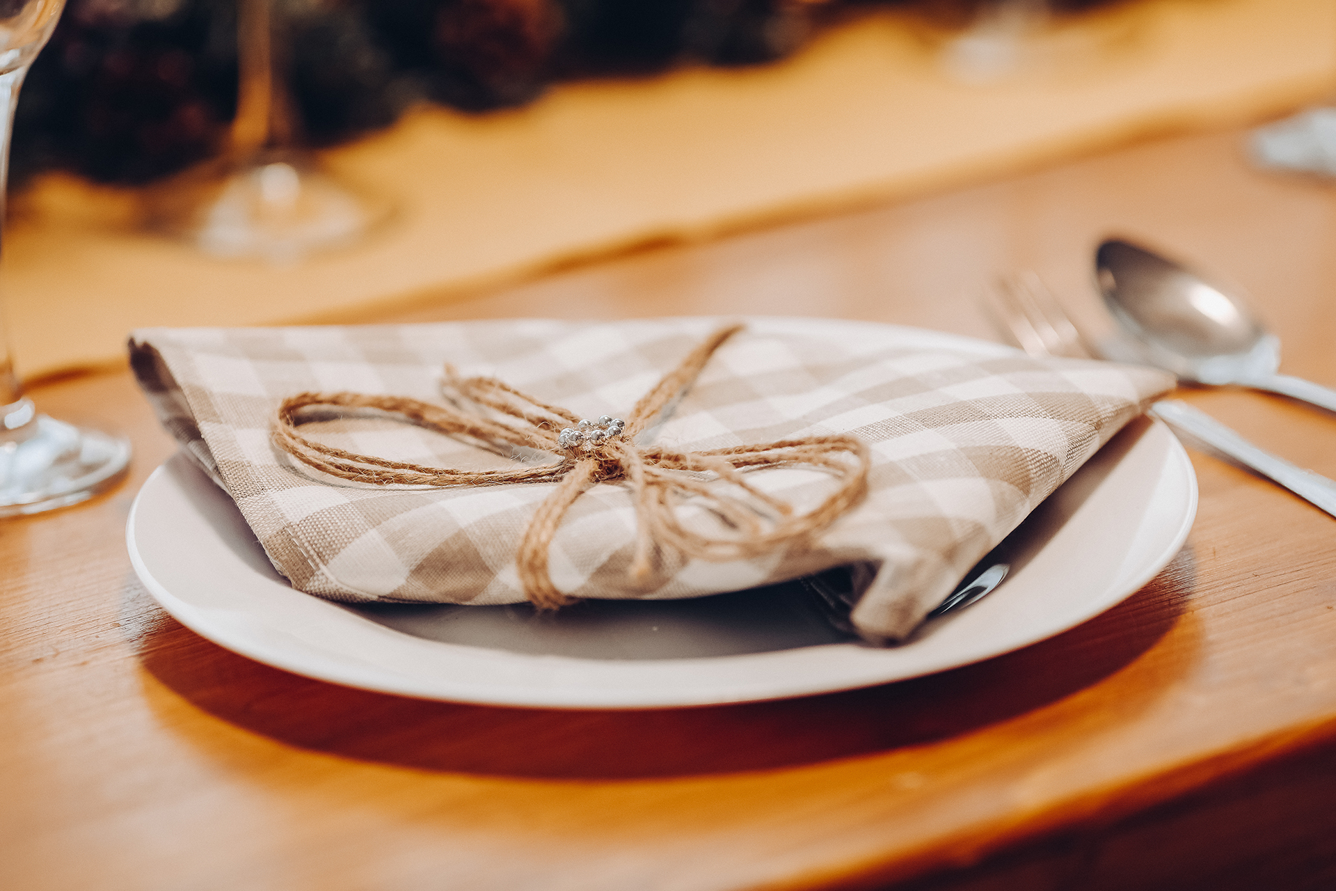 Plate served with checked napkin on dining table.