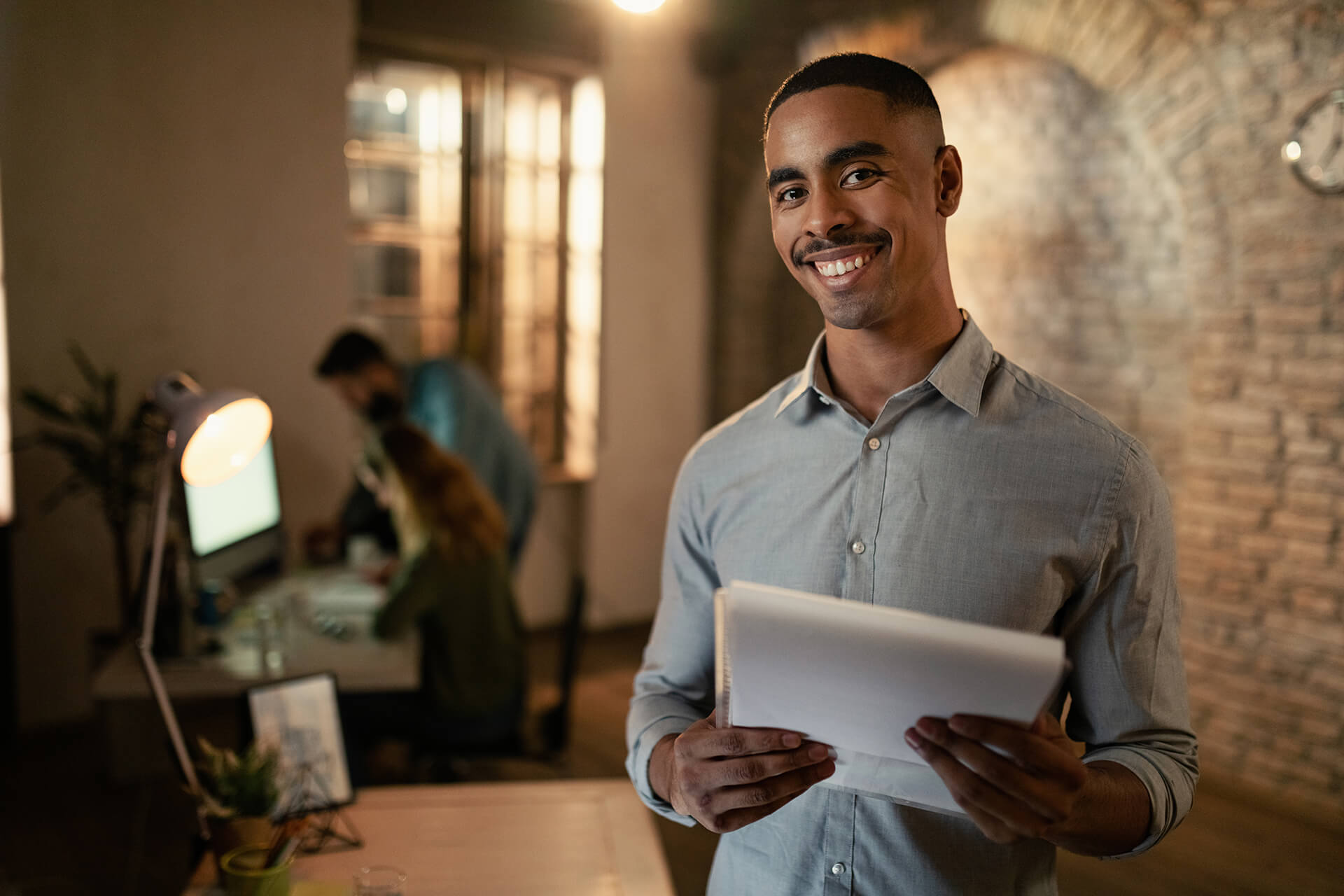 portrait-happy-black-entrepreneur-working-late-business-reports-looking-camera-office-2